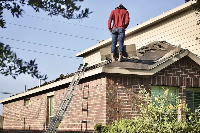 Professional roofer working on a residential roof in Garrison Park